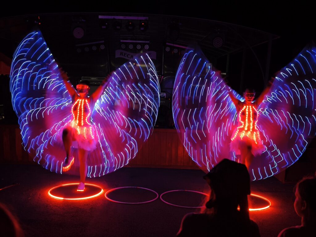two girls in led costumes with led wings